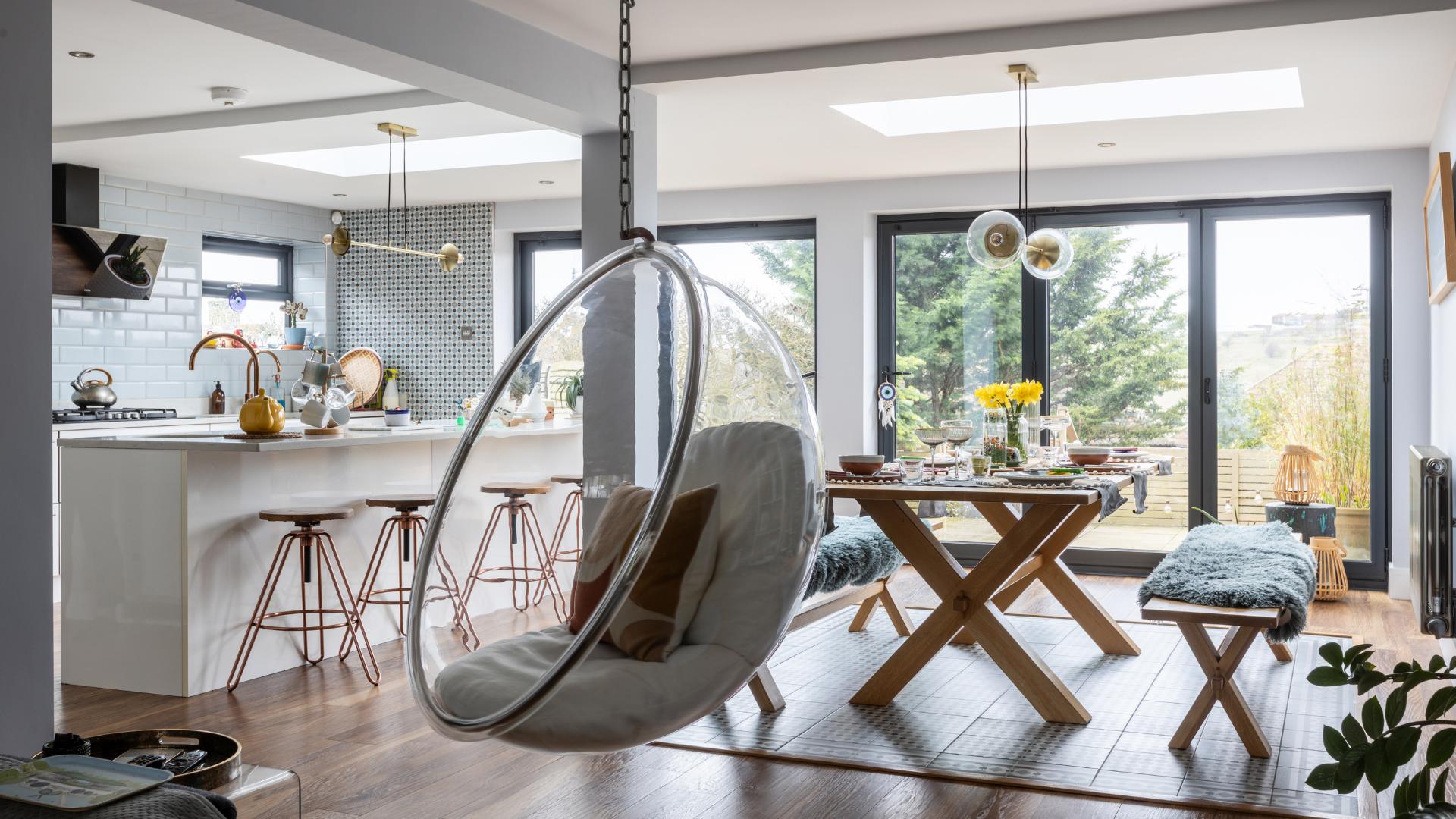 Open plan kitchen diner with hanging bubble chair